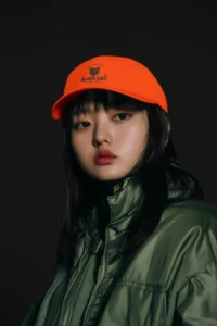 dad hat mockup featuring an ai created-woman with a cool style posing in a studio