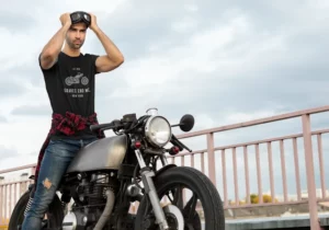 t-shirt mockup of a man putting on his motorcycle sunglasses
